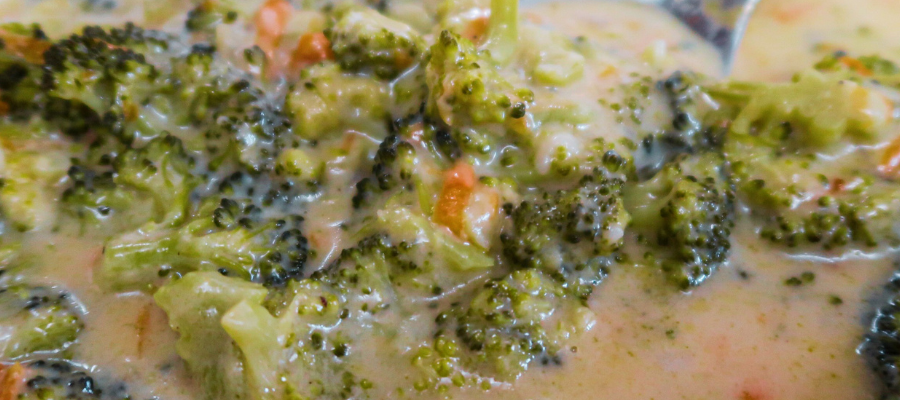 A picture of broccoli cheddar soup in a bowl